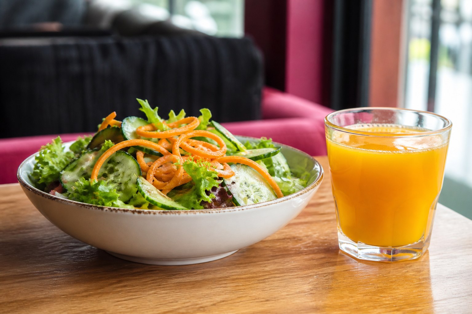 Fresh salad and a glass of freshly squeezed orange juice